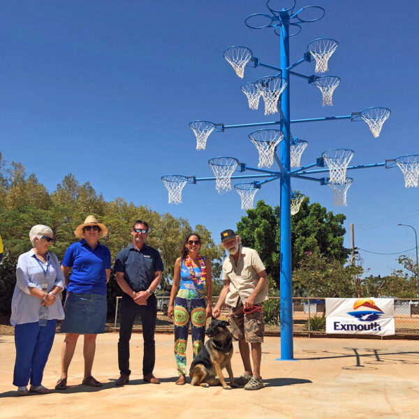 Exmouth_WA Raytheons Tom Leech, Exmouth Hospital social worker Dawn Ward, Exmouth CWA president Helen Turner, Shire of Exmouth president Matthew Niikkula, Free the Funk One Waves Zoe Gillam and Exmouth Mens Sheds Alan Duncan with the newly painted blue tree in Exmouth. Picture: Shire of Exmouth